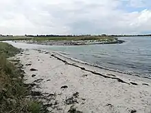 Halleby Ås udløb i Jammerland Bugt. I baggrunden ses brakvandssøen Flasken