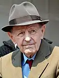 Portrait of Milos Jakes wearing a hat, tie and coat