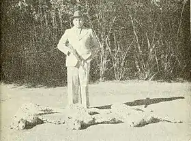 Maharaja Ramanuj Pratap Singh Deo standing beside the bodies of the last three wild cheetahs in India